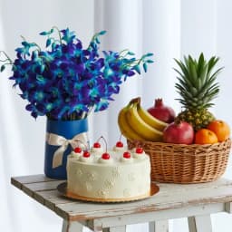 Lovely Blue Orchids in Vase with Mixed Fruits Butterscotch Cake N Sparkling Juice 1