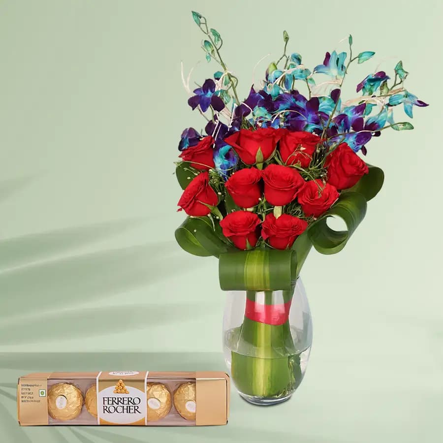 Enigmatic Red Roses n Blue Orchids in a Glass Vase with Ferrero Rocher Chocolates