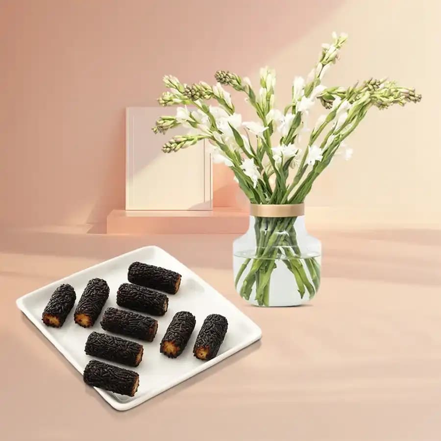 Kaju Choco Roll from Shree Mithai with Rajnigandha Stems in a Glass Vase
