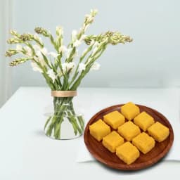 Mango Malai Barfi from Karachi Sweet Mart with a Rajnigandha Stems in a Glass Vase 1
