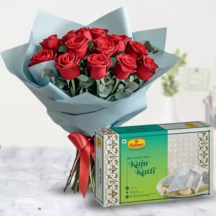 Lovely charming Red Roses combined with mouthwatering Kaju Katli