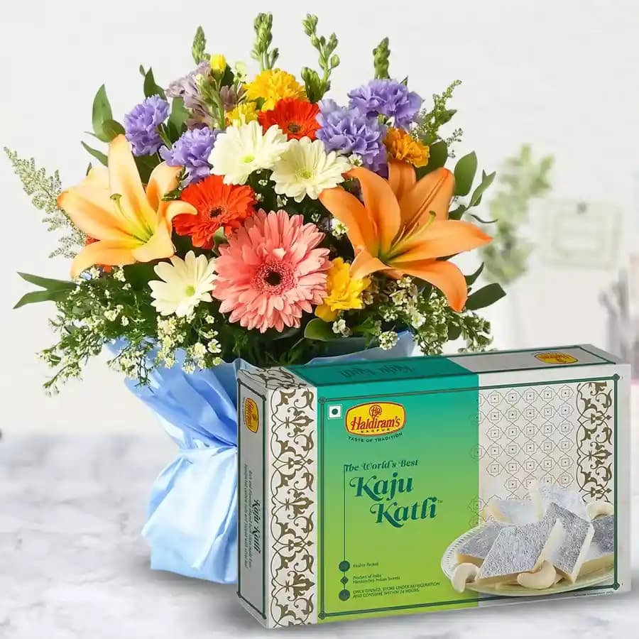 Beautiful fresh Seasonal Flower and delectable Kaju Barfi