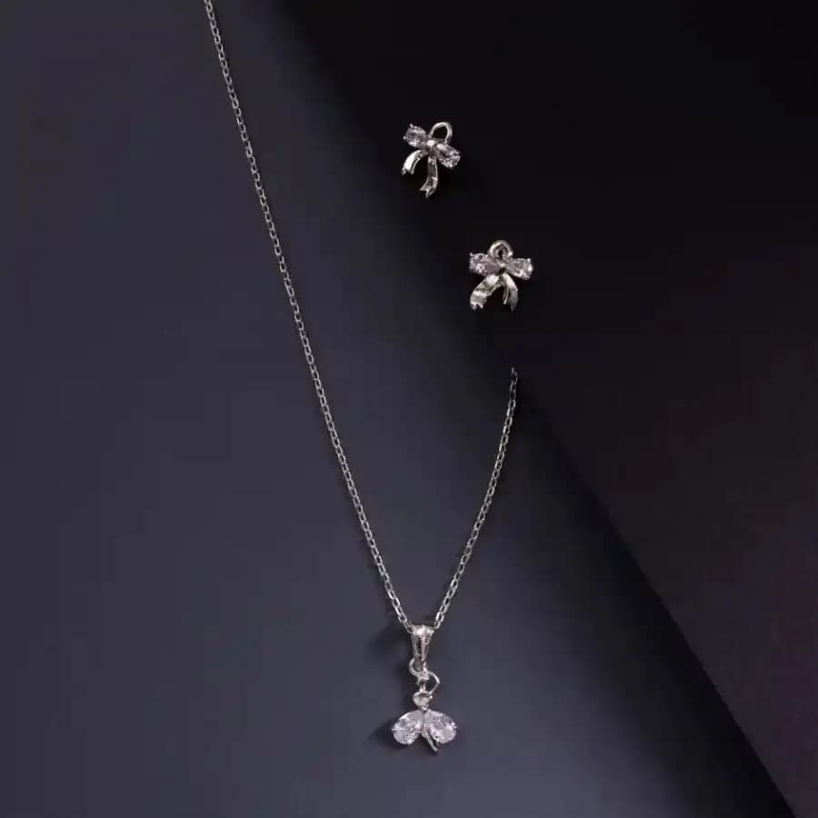 Charming Bow Charm: Silver Pendant & Earring Ensemble