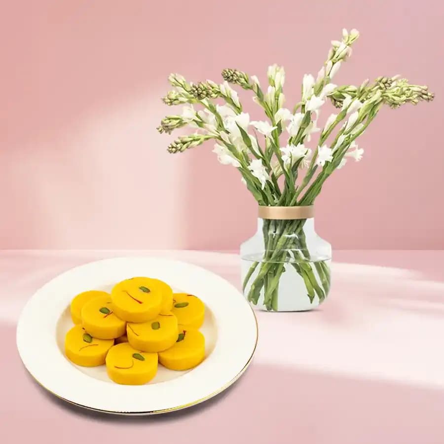 Kesar Peda from Dadus with a Rajnigandha Stems in a Glass Vase